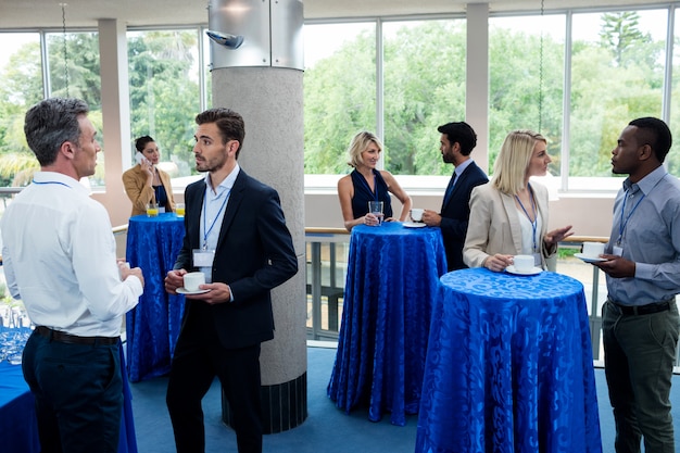 business-executives-interacting-with-each-other-while-having-coffee_107420-73037